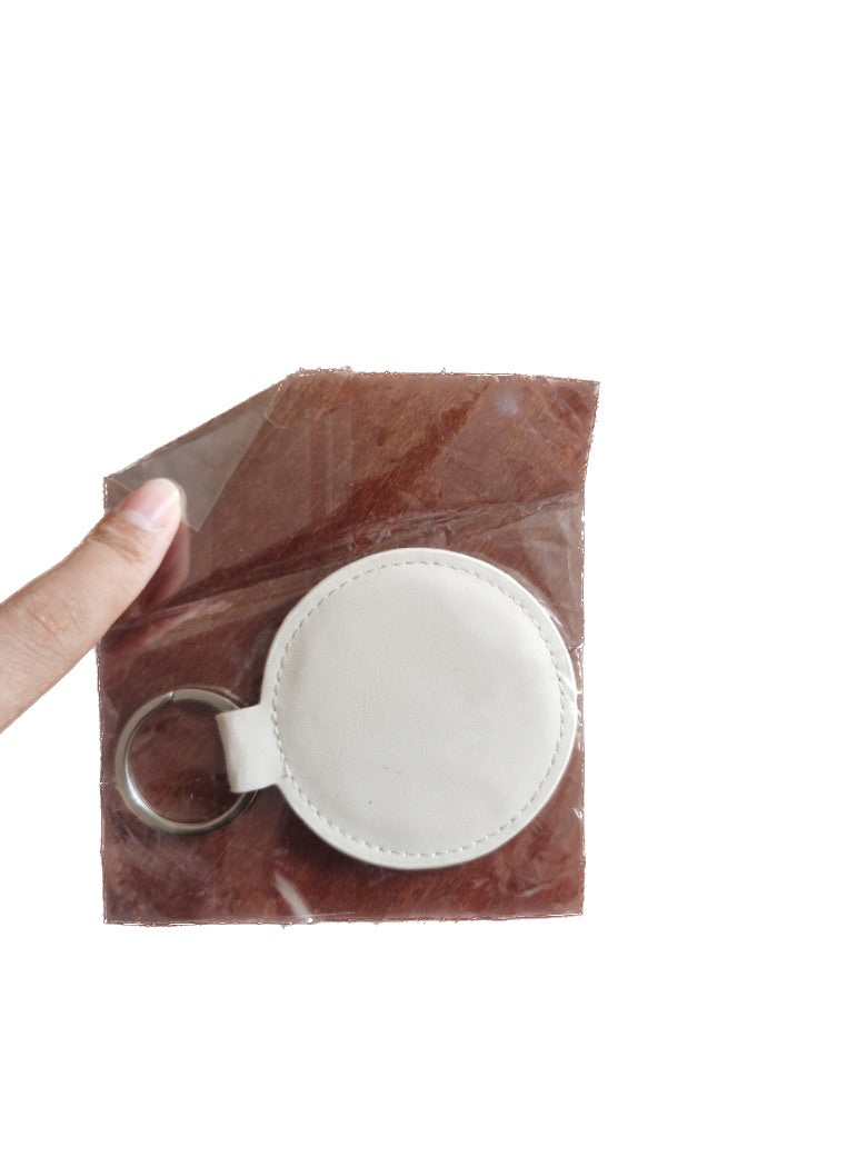 Porte-clés rond en cuir synthétique avec rembourrage